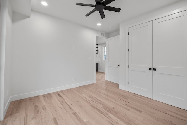 unfurnished bedroom featuring ceiling fan, a closet, and light hardwood / wood-style flooring