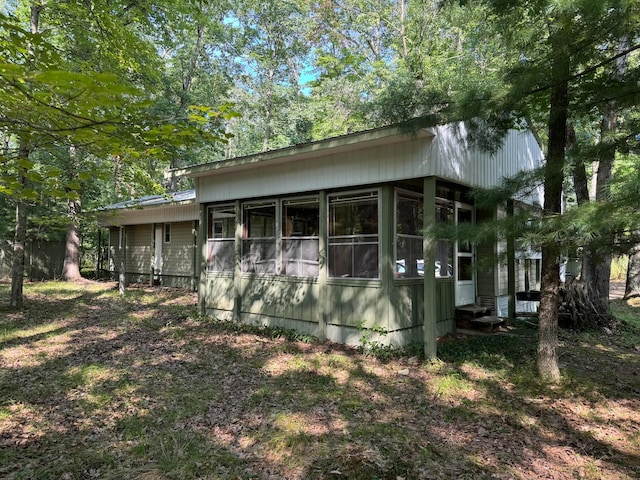 view of side of home with a sunroom