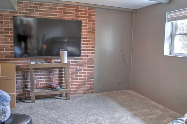 carpeted living room with wood walls