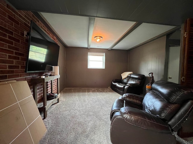 living room with carpet flooring, wooden walls, and brick wall