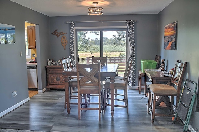 dining space with dark wood-type flooring