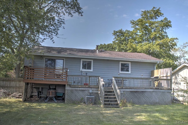 rear view of house with central AC, a yard, and a deck