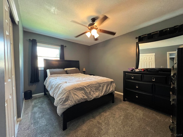 carpeted bedroom featuring a textured ceiling and ceiling fan