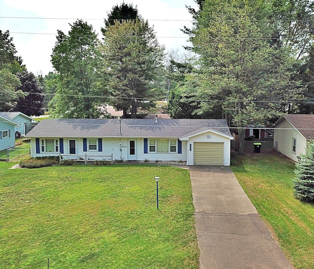 ranch-style house featuring a garage and a front lawn