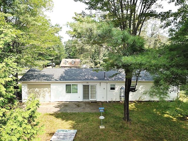 rear view of property featuring a lawn and a patio area