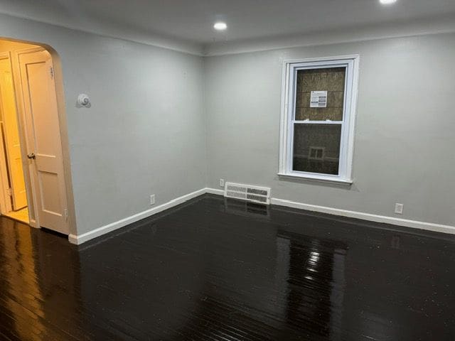 spare room featuring dark hardwood / wood-style floors