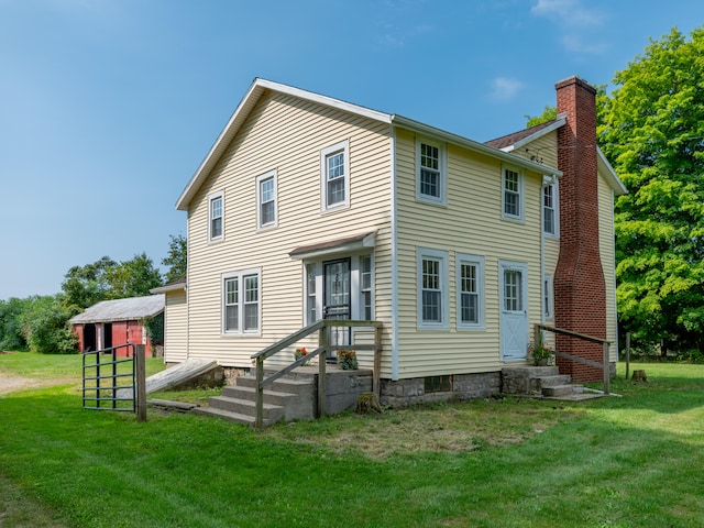 back of house with a lawn