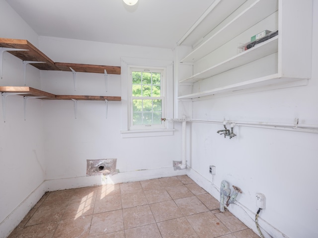 laundry room featuring light tile patterned flooring and hookup for an electric dryer