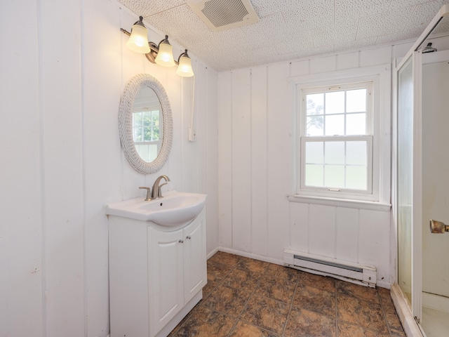 bathroom featuring vanity, a baseboard radiator, and wood walls