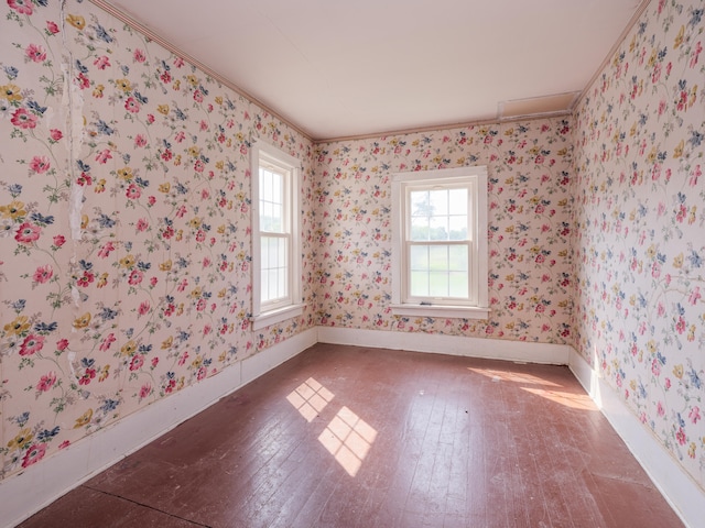 unfurnished room with hardwood / wood-style flooring and crown molding