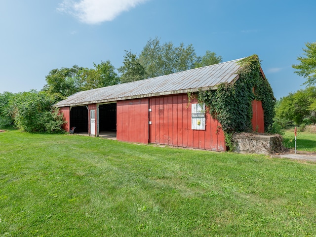 view of outbuilding featuring a lawn