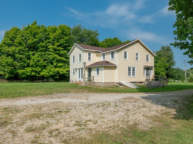 back of property featuring a yard