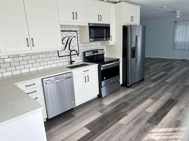 kitchen with white cabinets, stainless steel appliances, dark hardwood / wood-style floors, and ceiling fan