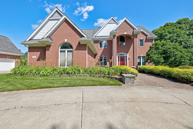 view of property with a front yard and a garage