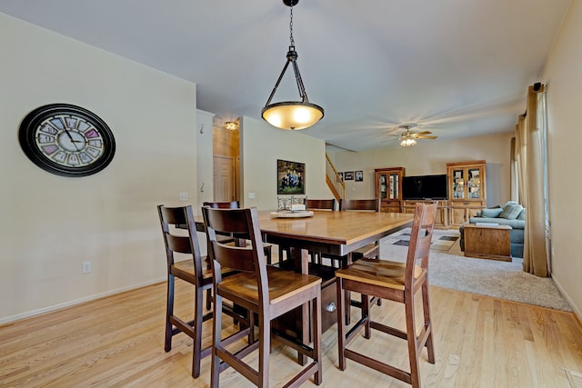 dining room featuring light hardwood / wood-style floors and ceiling fan