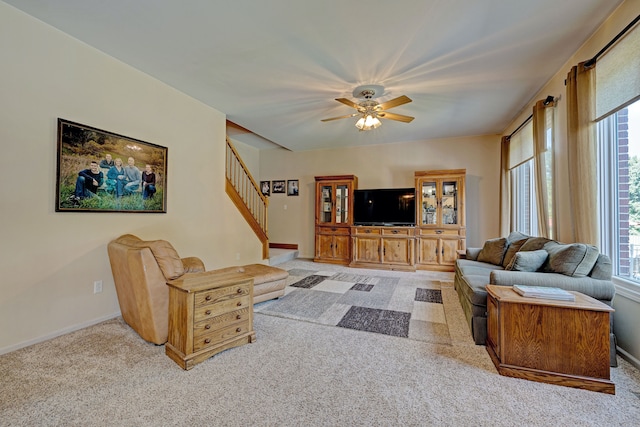 carpeted living room featuring ceiling fan