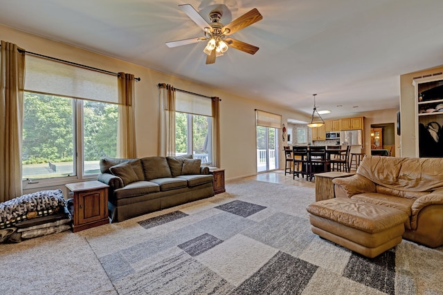 living room featuring ceiling fan and light colored carpet