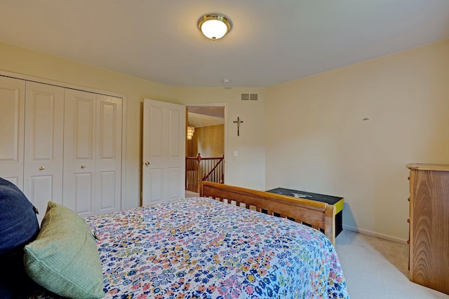 bedroom with a closet and light colored carpet