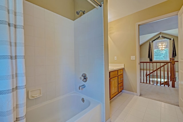 bathroom with tile patterned flooring, shower / tub combo, vanity, and a notable chandelier