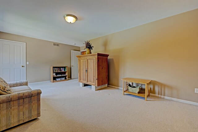 sitting room featuring light carpet