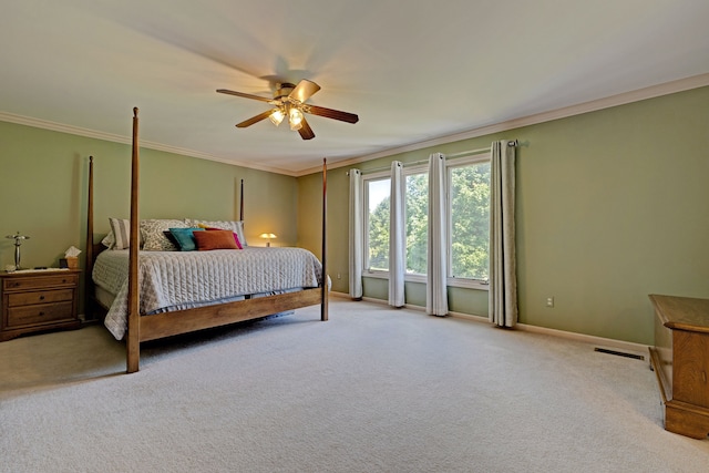 bedroom with ceiling fan, light colored carpet, and crown molding