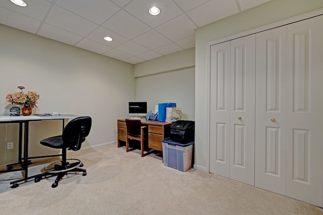 carpeted office space featuring a paneled ceiling