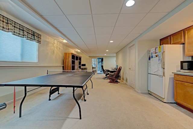 rec room featuring a drop ceiling and light colored carpet