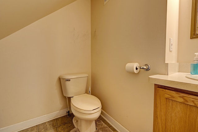 bathroom featuring tile patterned flooring, vanity, and toilet