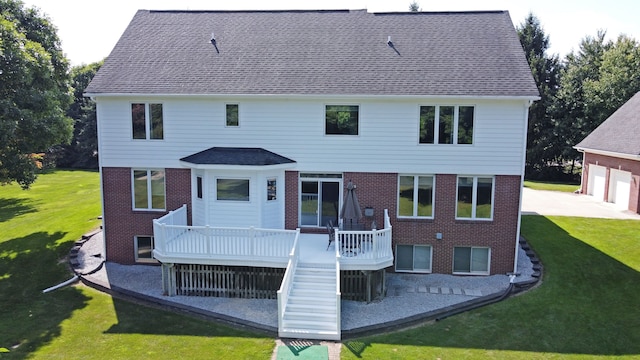 back of property with a lawn and a wooden deck