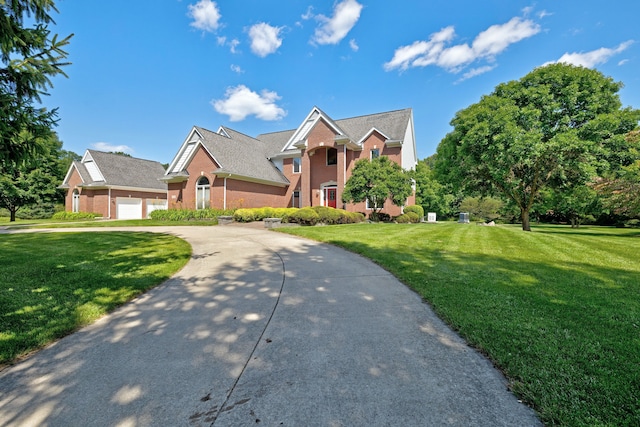 view of front of house featuring a garage and a front lawn