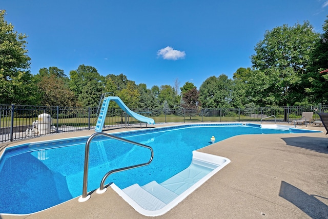 view of swimming pool featuring a patio area and a water slide