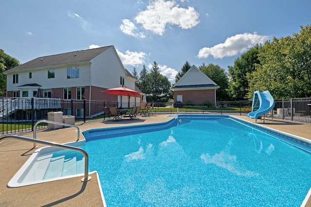 view of swimming pool featuring a patio area and a water slide