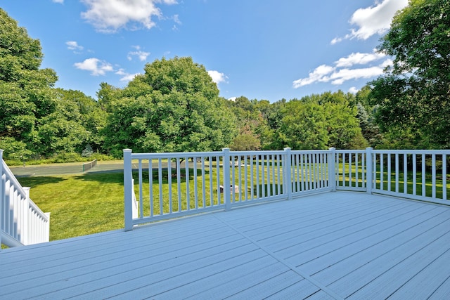 wooden deck featuring a yard