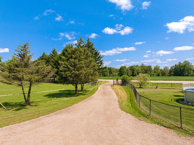 view of home's community with a lawn and a rural view