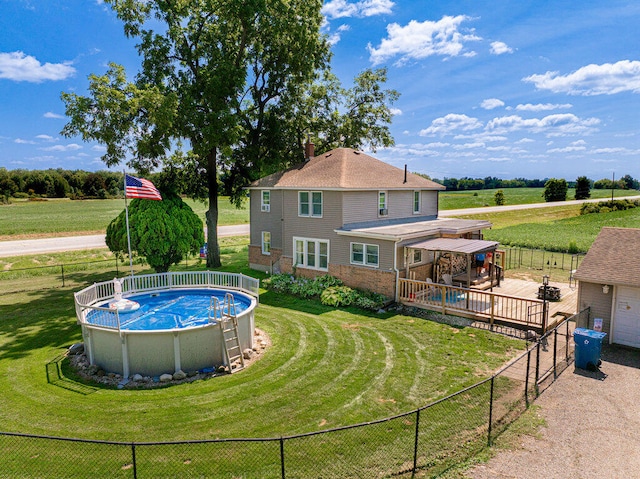 view of pool with a yard and a deck