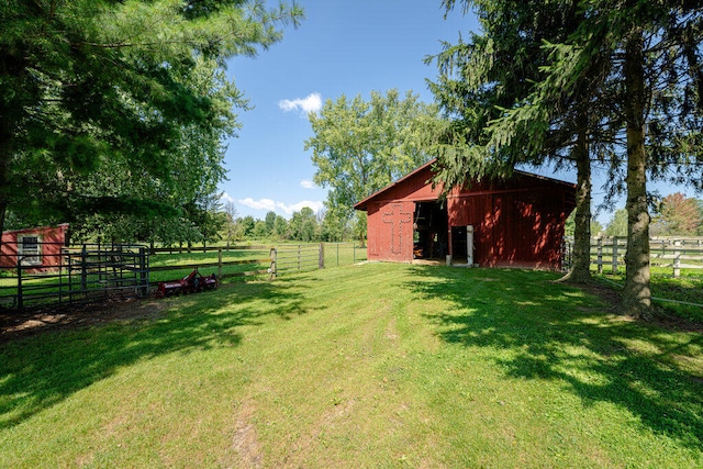 view of yard with a rural view and an outdoor structure