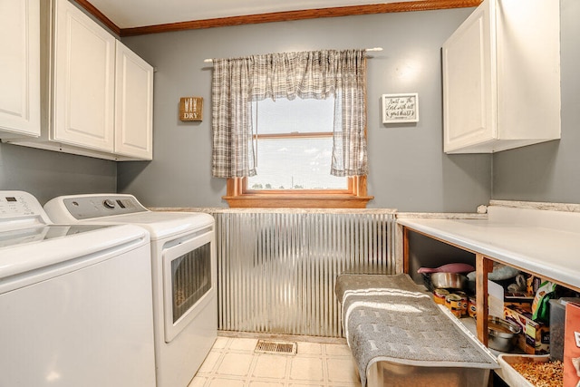 clothes washing area with cabinets, independent washer and dryer, and radiator