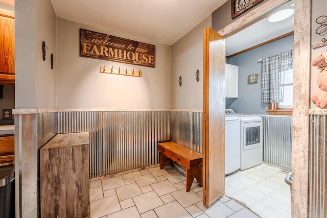 laundry room with cabinets, separate washer and dryer, and wooden walls