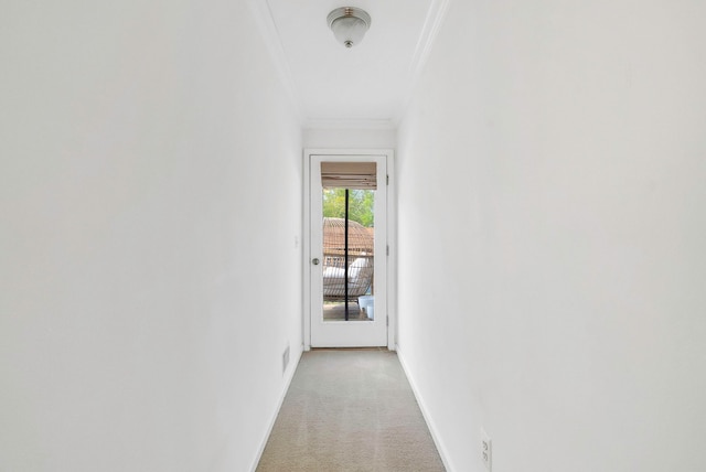 corridor featuring ornamental molding and light colored carpet