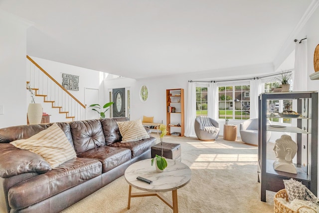 living room featuring crown molding and light carpet