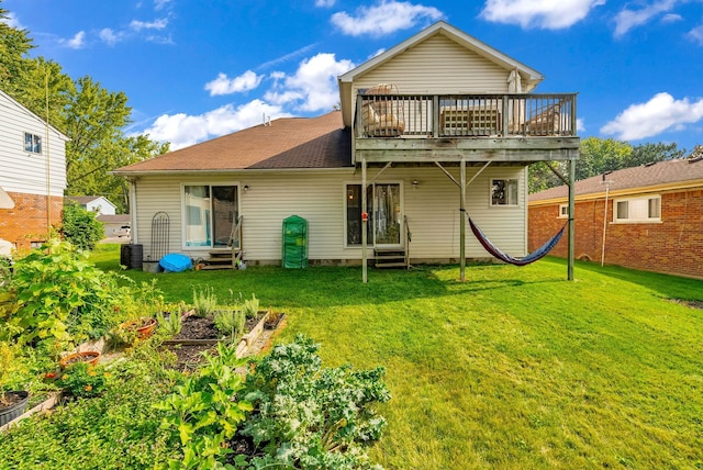 rear view of house with a lawn and a deck