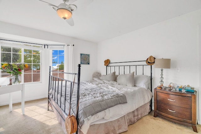 bedroom featuring light colored carpet and ceiling fan