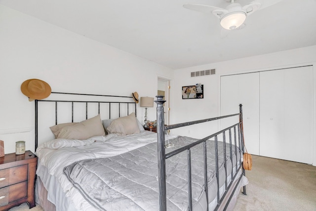 carpeted bedroom with ceiling fan and a closet