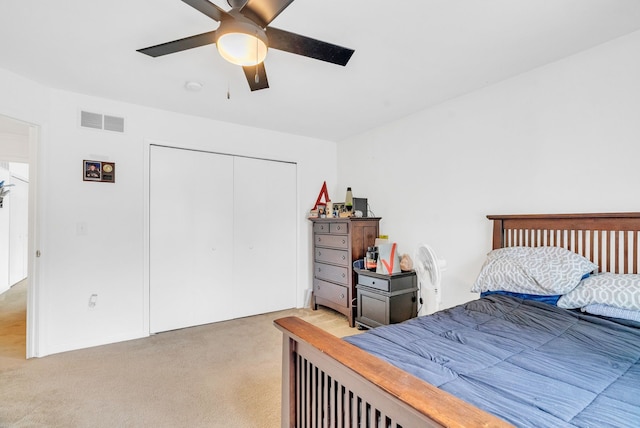 bedroom with a closet, ceiling fan, and carpet