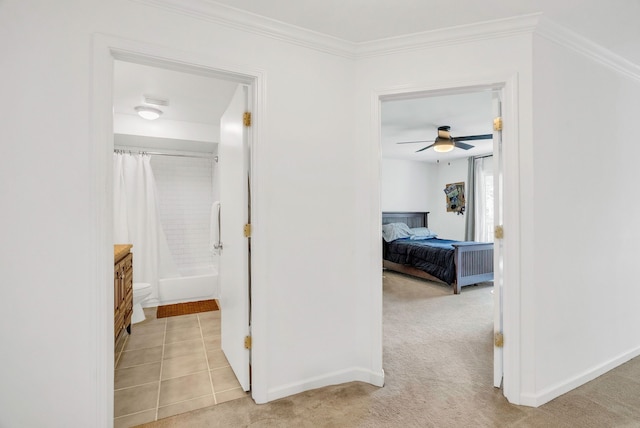 hall with light carpet and ornamental molding