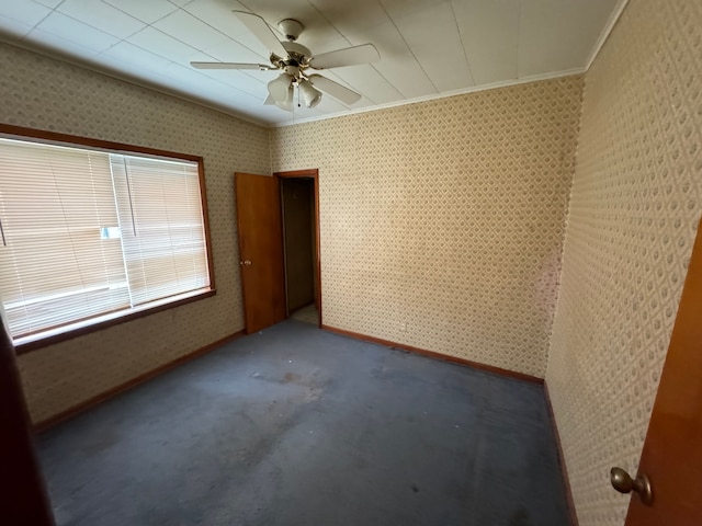 carpeted empty room featuring ceiling fan and ornamental molding