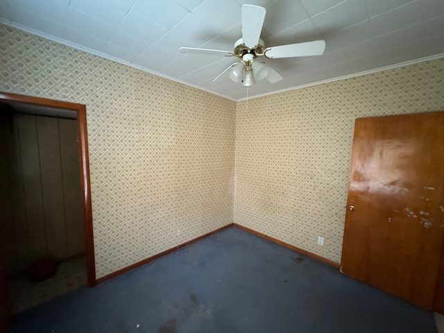 carpeted spare room with ceiling fan and crown molding