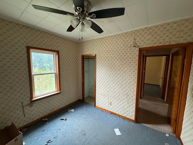 unfurnished bedroom featuring carpet and ceiling fan