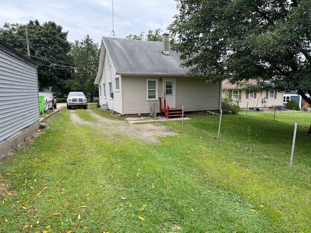 rear view of house with a yard