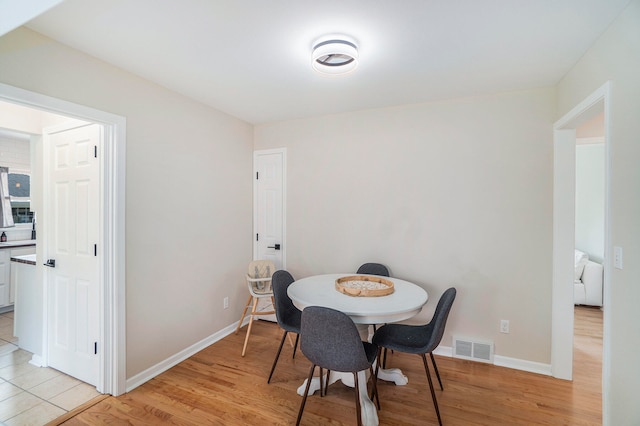 dining space with light wood-type flooring